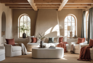 27 Home Decor Inspiration Ideas for Colorful Living Rooms and Bedrooms in 2025. Create a featured image The image captures a serene living room filled with earthy neutrals, setting the stage for cozy comfort. Soft beige and taupe tones dominate the space, creating a relaxed atmosphere. The natural wood beams and warm sunlight pouring through the windows enhance the inviting feel. Add brick red and moss green textiles and design elements