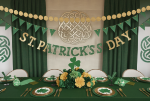 St Patrick's Day Decorations: Saint Patrick’s Day Party Decor setup including gold coin garland, emerald green table settings, St Patricks Day banner and bunting, Celtic knot wall art and a shamrock and green and gold flower centerpiece.