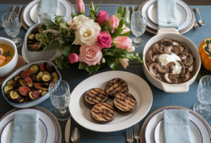 A table set for an easter feast with serving dishes of unique low carb Keto Easter dinner menu ideas dishes side on. Include coconut curry shrimp soup, ratatouille with zucchini and eggplant with bright vegetables like tomato and peppers, grilled portobello mushroom beef burgers with tomato and cheese, beef stroganoff with real pieces of beef and mushrooms and acorn squash with cheesy sausage and spinach showing pieces of sausage spinach and topped with melted cheese.